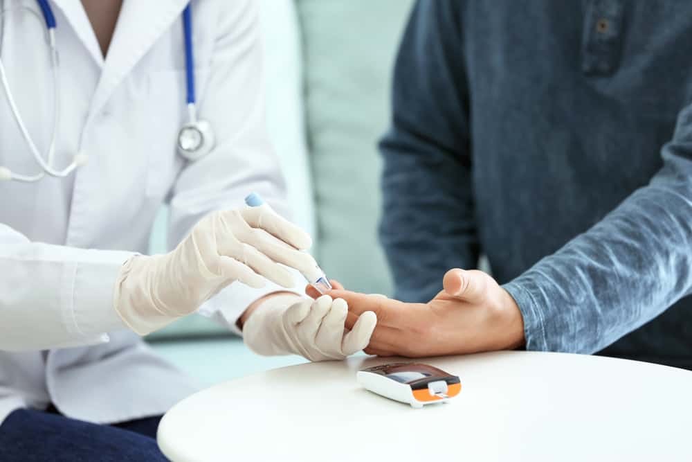 A doctor pinpricking a diabetic.