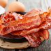 Closeup of bacon in a pan on a table.