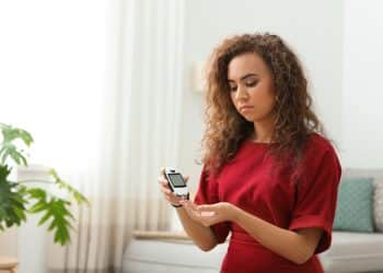 A woman testing her blood glucose levels.