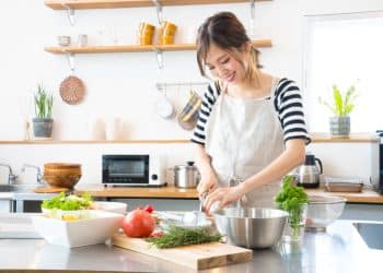 A woman preparing some food in her kitchen.