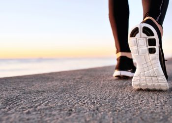A closeup of someone's shoes as they get ready to run to workout.
