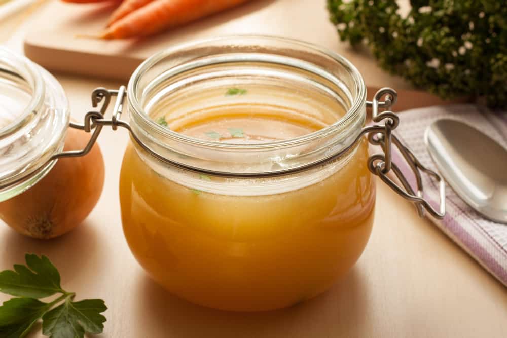 A closeup of a container of bone broth.