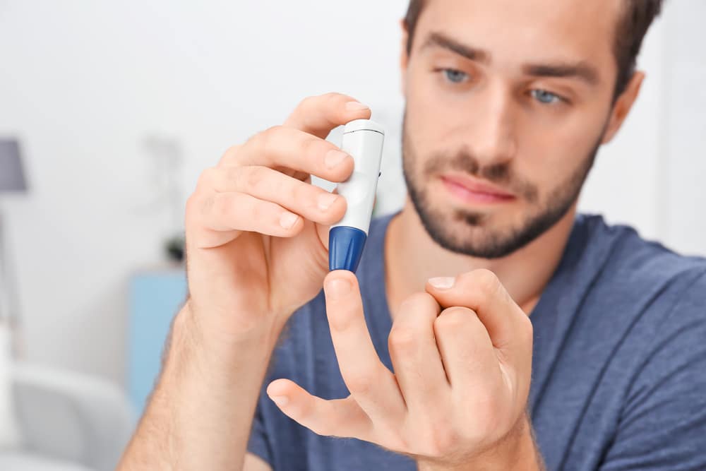 A man checking his blood glucose levels.
